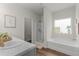 Bathroom featuring a bathtub, standing shower, and a white sink with gold accents at 197 Cherokee Reserve Cir, Canton, GA 30115