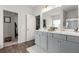 Bright bathroom featuring double sinks with gray cabinets, gold handles and faucet at 197 Cherokee Reserve Cir, Canton, GA 30115