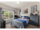 Bedroom featuring a large window, gray dresser and a blue color scheme at 197 Cherokee Reserve Cir, Canton, GA 30115