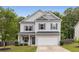 Charming home with a manicured lawn, two car garage and covered front porch at 197 Cherokee Reserve Cir, Canton, GA 30115