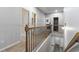 Upstairs hallway with neutral carpet, railing, and bright walls at 197 Cherokee Reserve Cir, Canton, GA 30115