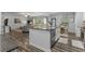 Open-concept living area featuring an island kitchen with stainless steel appliances and granite countertops at 197 Cherokee Reserve Cir, Canton, GA 30115