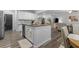 Open-concept kitchen with a granite island, stainless steel appliances, and adjacent living space at 197 Cherokee Reserve Cir, Canton, GA 30115