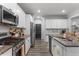 Modern kitchen with white cabinets, stainless steel appliances, and granite countertops at 197 Cherokee Reserve Cir, Canton, GA 30115