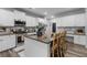 Stylish kitchen island with bar stool seating, granite countertops, and stainless steel appliances at 197 Cherokee Reserve Cir, Canton, GA 30115
