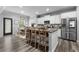 Modern kitchen featuring white cabinets, granite countertops, stainless steel appliances, and breakfast bar at 197 Cherokee Reserve Cir, Canton, GA 30115