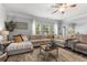 Bright living room with large sectional sofa, stylish rug, and ample natural light at 197 Cherokee Reserve Cir, Canton, GA 30115