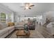 Open-concept living space with hardwood floors, large sectional sofa, and modern decor at 197 Cherokee Reserve Cir, Canton, GA 30115