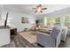 Well-lit living room with comfortable seating, a ceiling fan and elegant decor at 197 Cherokee Reserve Cir, Canton, GA 30115