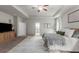 Bright main bedroom featuring a ceiling fan, TV and sitting area, and large rug at 197 Cherokee Reserve Cir, Canton, GA 30115