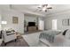 Bright main bedroom featuring a ceiling fan, TV and sitting area, and large rug at 197 Cherokee Reserve Cir, Canton, GA 30115