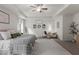 Spacious main bedroom featuring a ceiling fan, sitting area, and a large rug at 197 Cherokee Reserve Cir, Canton, GA 30115