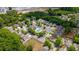 Panoramic aerial view of a residential area featuring community pool, clubhouse, and mature landscaping at 2545 Gatewater Ct, Cumming, GA 30040