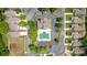 Aerial view of a community pool and clubhouse surrounded by lush landscaping and well-maintained homes at 2545 Gatewater Ct, Cumming, GA 30040