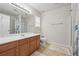 Bright bathroom featuring a vanity with a large mirror, a toilet, and a shower-tub combo with tiled flooring at 2545 Gatewater Ct, Cumming, GA 30040