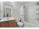 Bathroom featuring a combined tub and shower with white tiling and updated fixtures at 2545 Gatewater Ct, Cumming, GA 30040