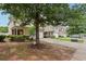 Landscaped front yard with mature trees enhances the curb appeal of these inviting townhomes at 2545 Gatewater Ct, Cumming, GA 30040