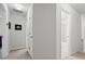 Hallway view featuring neutral paint, white trim and doors, and access to bath and bedroom areas at 2545 Gatewater Ct, Cumming, GA 30040