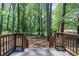 View of backyard from wooden deck and railing showcasing large trees at 2975 Rollingwood Se Ln, Atlanta, GA 30316