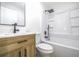 Modern bathroom featuring bathtub and shower combination, a wooden vanity and updated fixtures at 2975 Rollingwood Se Ln, Atlanta, GA 30316