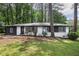 Charming renovated single-story brick home with a well-manicured lawn, set amongst mature trees at 2975 Rollingwood Se Ln, Atlanta, GA 30316