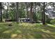 Spacious front yard with mature trees, providing shade and enhancing curb appeal at 2975 Rollingwood Se Ln, Atlanta, GA 30316