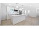 Bright, open kitchen featuring a center island with seating and modern stainless steel appliances at 2975 Rollingwood Se Ln, Atlanta, GA 30316