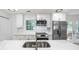 Bright kitchen with stainless steel appliances, white cabinets, and quartz countertops at 2975 Rollingwood Se Ln, Atlanta, GA 30316