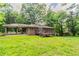 The backyard features a covered patio, deck, and ample green space, ideal for outdoor activities at 4567 Parkway Cir, Atlanta, GA 30349