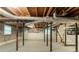 Unfinished basement with exposed wood ceiling and support beams at 4567 Parkway Cir, Atlanta, GA 30349