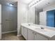 Bathroom featuring dual sinks, a large mirror, and a separate toilet room at 4567 Parkway Cir, Atlanta, GA 30349