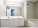 Bathroom with dual vanity, large mirror and combined tub and shower at 4567 Parkway Cir, Atlanta, GA 30349