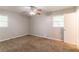 A bright bedroom features a ceiling fan and two windows to allow for natural light at 4567 Parkway Cir, Atlanta, GA 30349