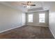 Bright bedroom with tray ceiling, fan, and natural light from two windows at 4567 Parkway Cir, Atlanta, GA 30349