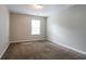 Neutral bedroom with a window providing natural light and carpeted floor at 4567 Parkway Cir, Atlanta, GA 30349