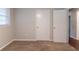 This cozy bedroom features neutral walls, plush carpeting, and a window for natural light at 4567 Parkway Cir, Atlanta, GA 30349