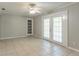Open dining area with tile flooring, a ceiling fan, and French doors leading to the outside at 4567 Parkway Cir, Atlanta, GA 30349