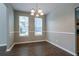 Dining room featuring hardwood floors, neutral walls, updated lighting and views to the exterior at 4567 Parkway Cir, Atlanta, GA 30349
