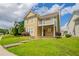 Inviting two-story home with a balcony, complemented by a lush green lawn and a serene neighborhood setting at 4567 Parkway Cir, Atlanta, GA 30349