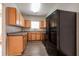 This kitchen features light wood cabinetry, dark countertops, modern black appliances and wood floors at 4567 Parkway Cir, Atlanta, GA 30349