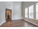 Spacious living room featuring hardwood floors, large windows with shades and neutral colored walls at 4567 Parkway Cir, Atlanta, GA 30349