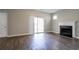 Comfortable living room featuring a classic fireplace, a sliding glass door, and stylish wood-look floors at 4567 Parkway Cir, Atlanta, GA 30349