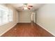 Spacious living room featuring wood flooring, a ceiling fan, and ample natural light at 4567 Parkway Cir, Atlanta, GA 30349