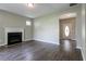 Inviting living room with a cozy fireplace and dark, modern flooring leading to the home's entrance at 4567 Parkway Cir, Atlanta, GA 30349