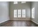 Spacious living room featuring hardwood floors, large windows with shades and neutral colored walls at 4567 Parkway Cir, Atlanta, GA 30349