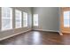 Spacious living room featuring hardwood floors, large windows with shades and neutral colored walls at 4567 Parkway Cir, Atlanta, GA 30349