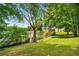 A lush green lawn leads to a lake with a dock and multiple neighbor's docks at 507 Cross Creek Pt, Stone Mountain, GA 30087
