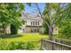 The backyard of the home features a patio area and lush green lawn down to the lake at 507 Cross Creek Pt, Stone Mountain, GA 30087