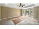 Bedroom features a tray ceiling, ceiling fan, a large bay window, and a door to the outside at 507 Cross Creek Pt, Stone Mountain, GA 30087