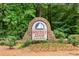 Stone sign for the Water's Edge community surrounded by lush landscaping and trees at 507 Cross Creek Pt, Stone Mountain, GA 30087